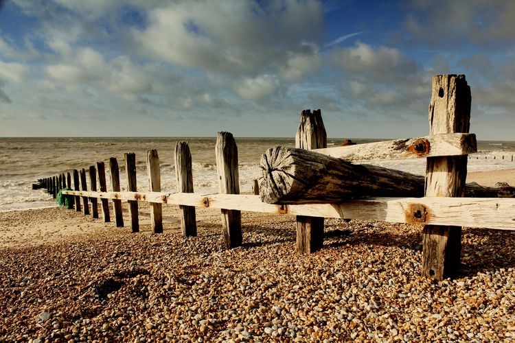 Wooden-beamed fence going into the sea