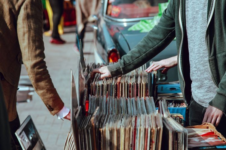 People scanning through rows of vinyl records  