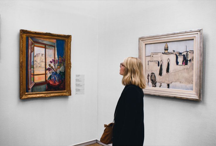 Woman looking at a piece of art